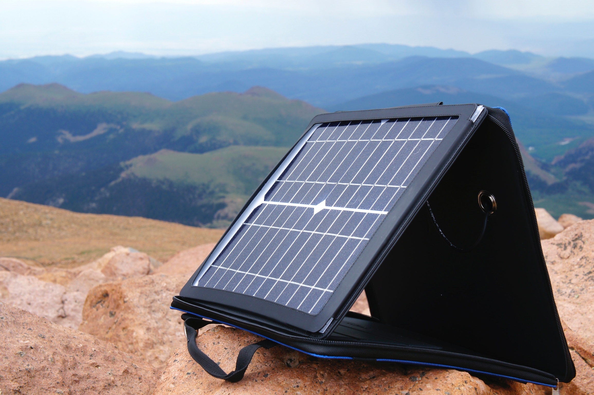 SunVolt portable solar charger on a mountain overlook